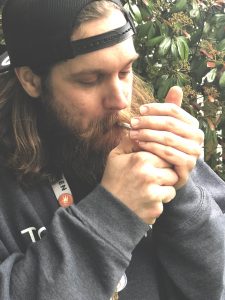 Educator Jared smoking on a preroll